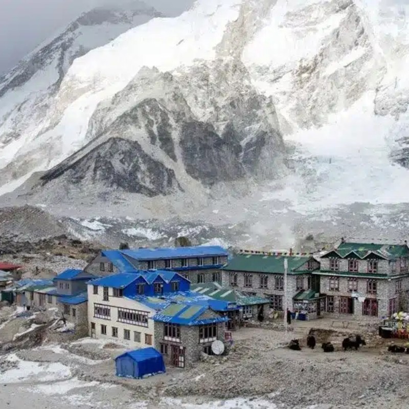 Mountain lodges in Gorakshep beneath snowy Himalayan peaks near Everest Base Camp.