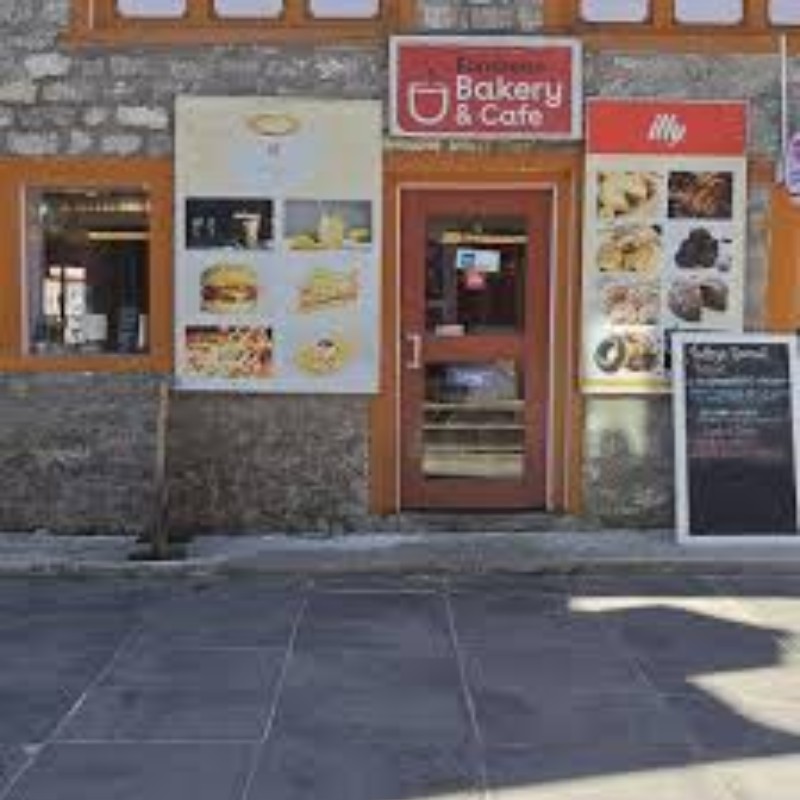 Cafe 4410 bakery and café storefront in Lukla with menu displays outside
