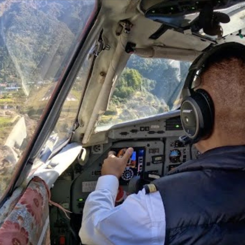Pilot landing an aircraft at Lukla Airport from inside the cockpit