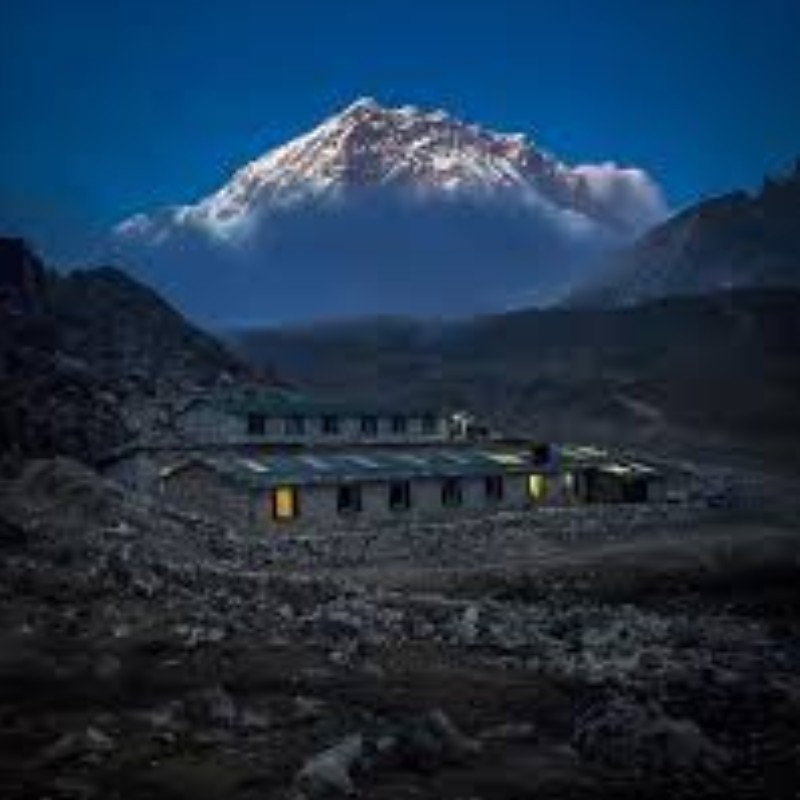 Sunset glow over snowy Himalayan peaks above Lobuche village in the Everest region.