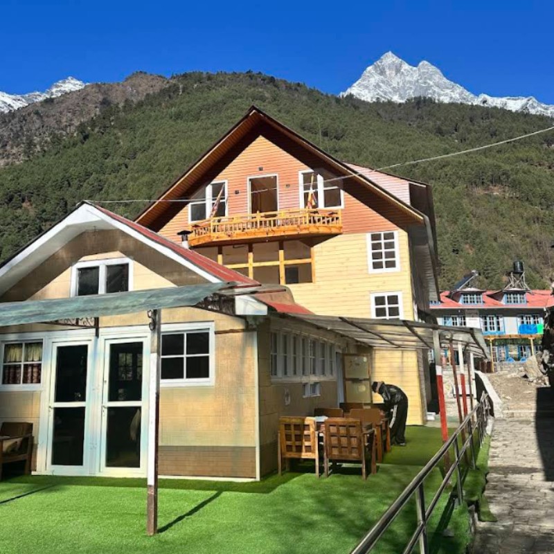 Namaste Lodge in Phakding with mountain backdrop and outdoor seating area