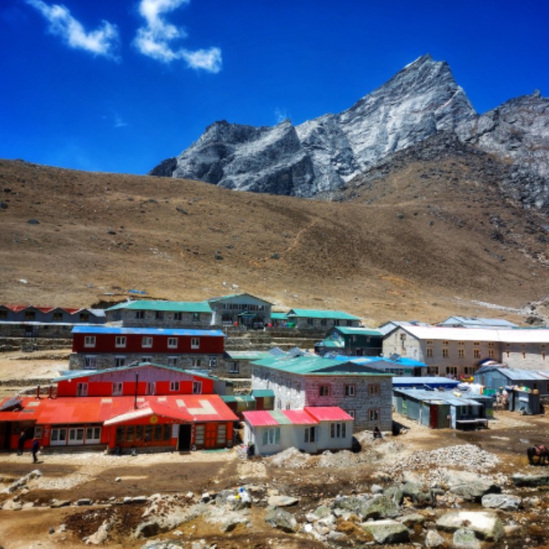 Colorful tea houses and lodges in Lobuche beneath rugged Himalayan peaks in Nepal.