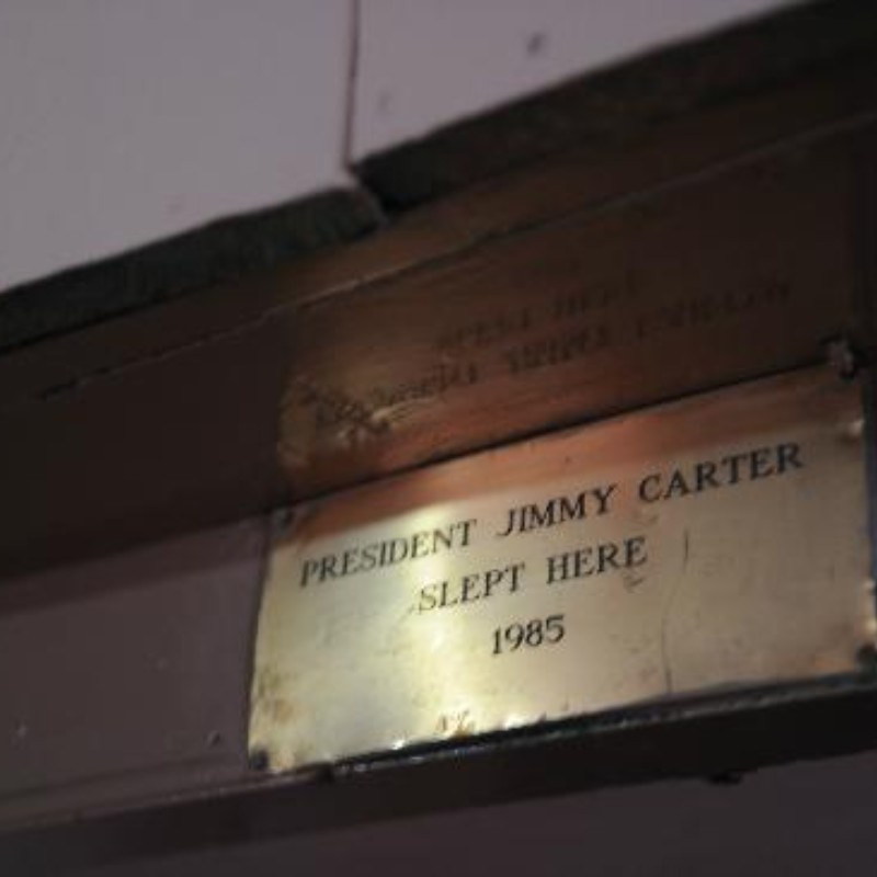 A commemorative plaque inside a mountain lodge stating President Jimmy Carter slept here in 1985