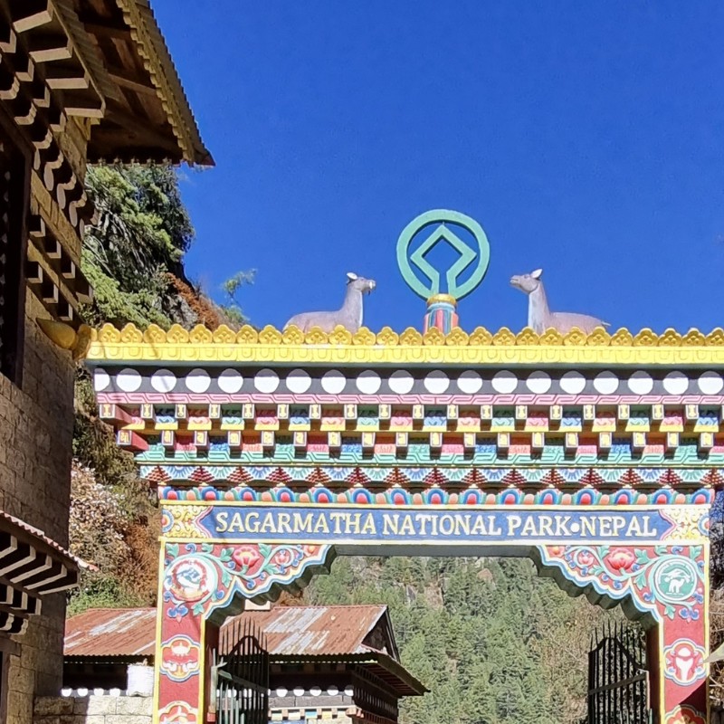 Colorful entrance gate of Sagarmatha National Park in Nepal with traditional Himalayan Buddhist design.