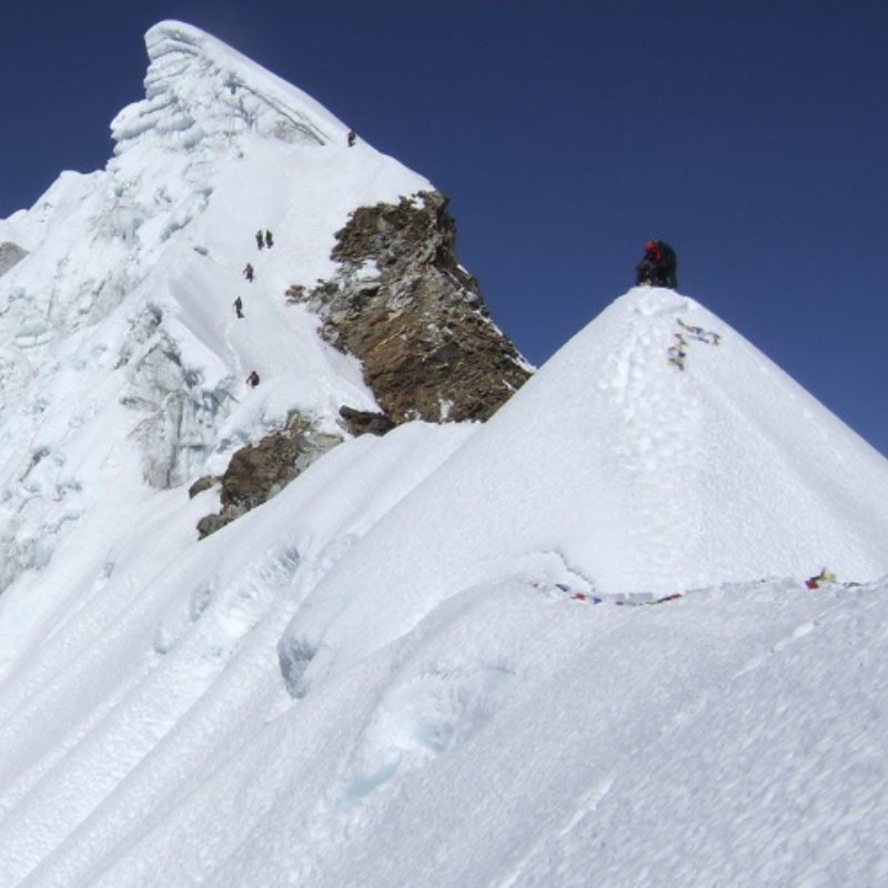 Climbers ascending the snowy ridge of Lobuche Peak in Nepal’s Everest region.
