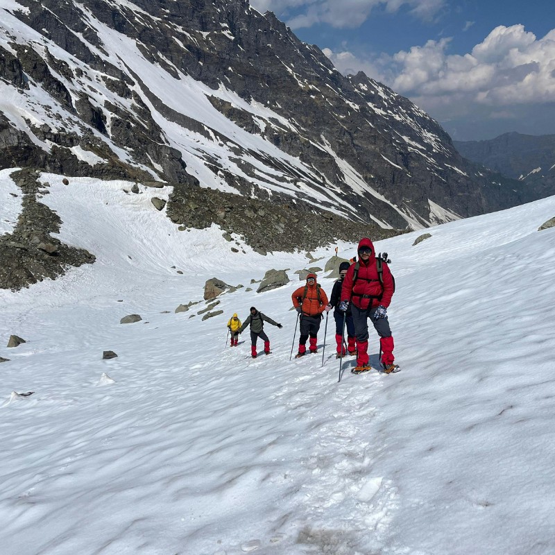 Trekkers crossing a snowy high pass during the Everest Three Pass Trek in Nepal.